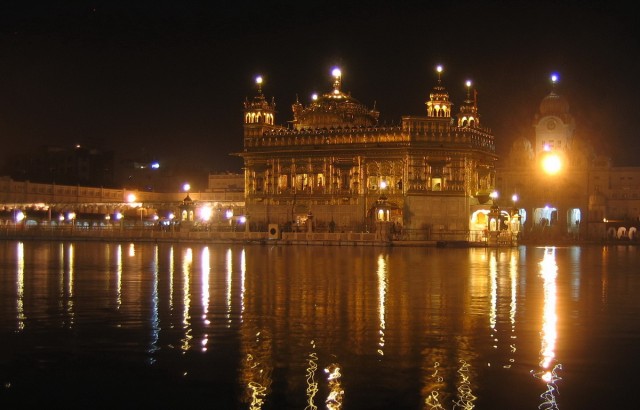 the golden temple of the Sikh, a specific religious branch, covered in gold, there is a continuous flow of pelgrims visiting